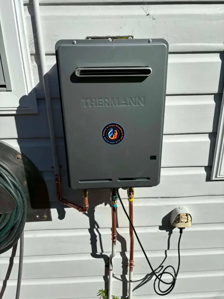 A continuous flow gas water heater on weatherboard cladding